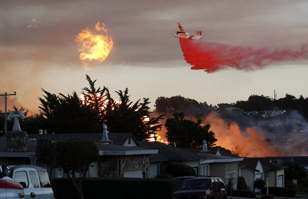 A plane spreads fire retardent on the San Bruno fire.