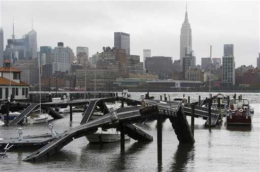 The twisted remains of a Hudson River marina are seen across from New York City as a result of superstorm Sandy on Tuesday, Oct. 30, 2012 in Hoboken, NJ. (AP Photo/Charles Sykes)