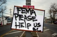 A sign asking for help from the Federal Emergency Management Agency on Friday in the Broad Channel section of Queens.