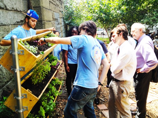 Teenagers in Greenpoint's SYSTEM program construct a vertical garden.